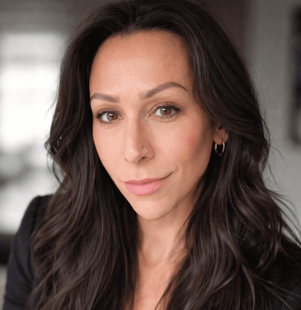 Woman with brown hair looking at camera