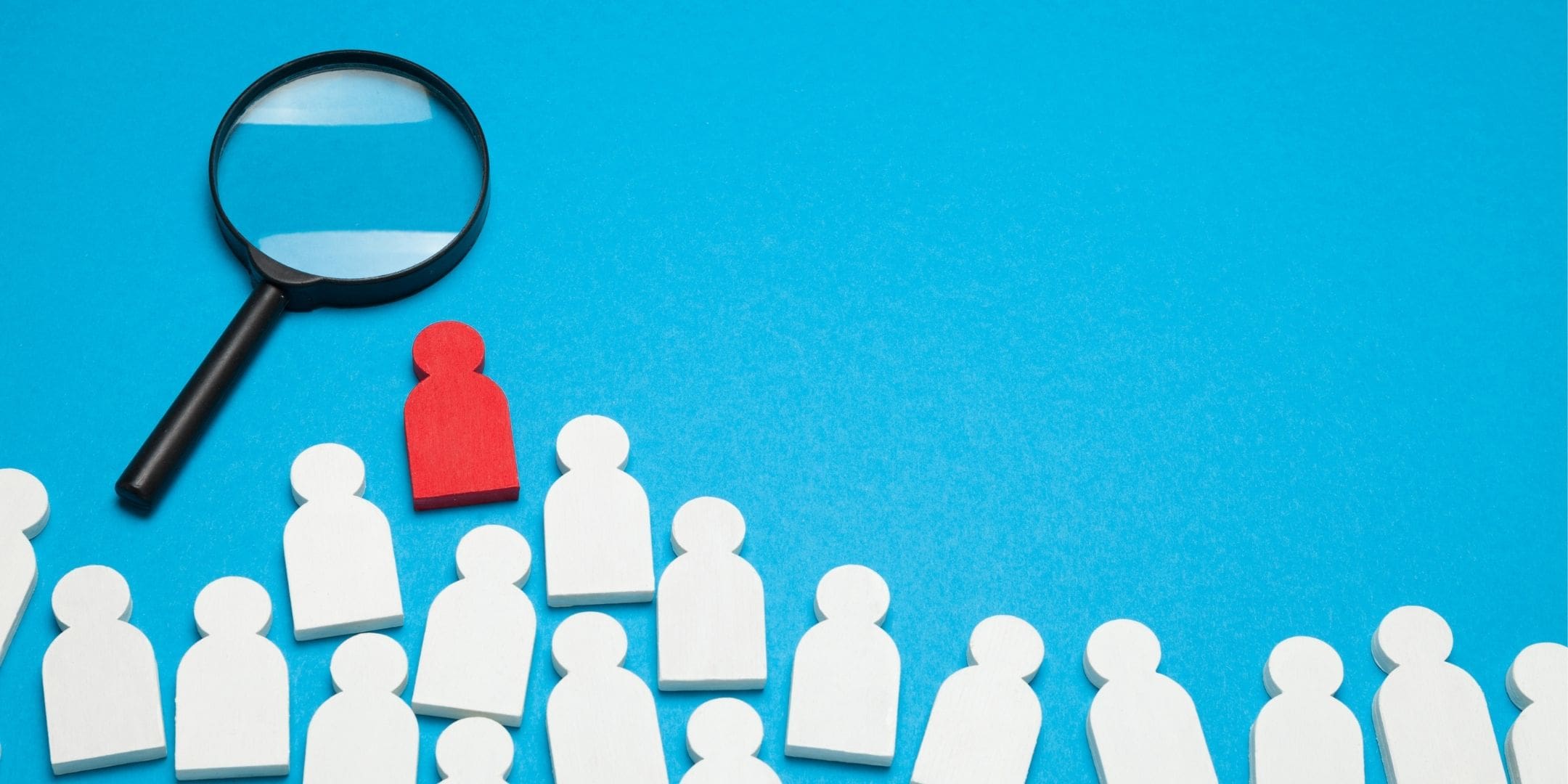 magnifying glass honing in on a red figure out of many possible pieces