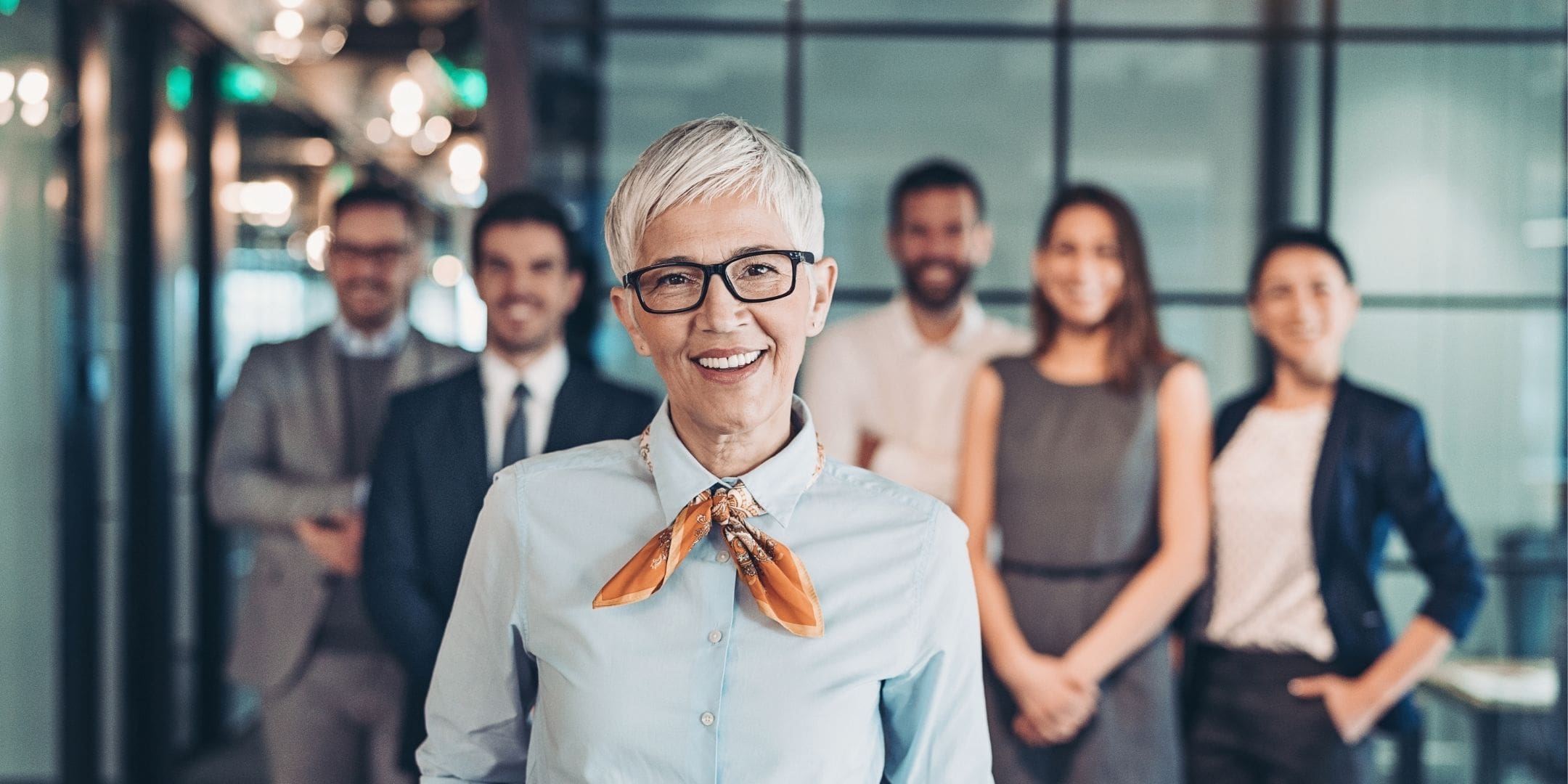 Leadership team with female leader in forefront